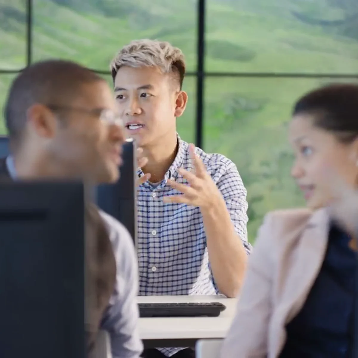 A technical instructor leading a discussion with colleagues in a modern training environment